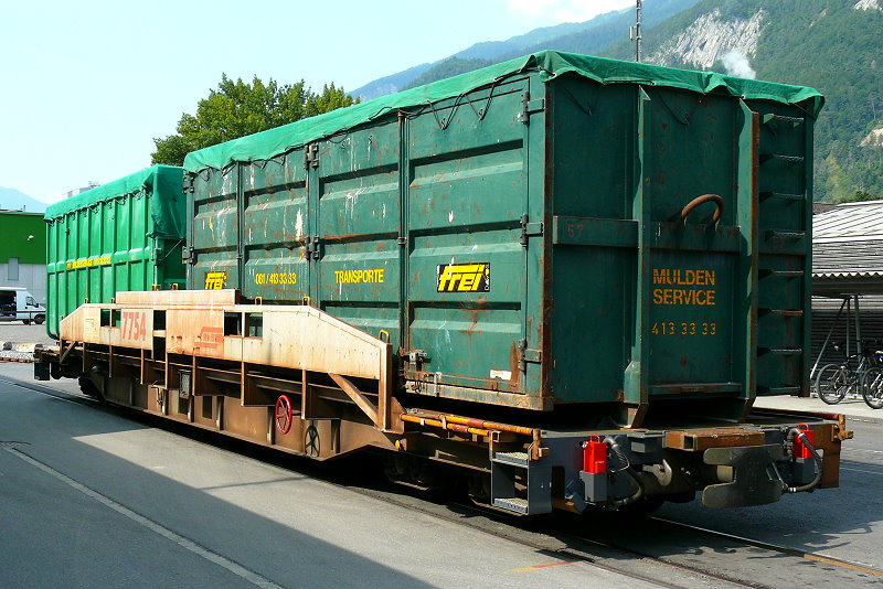 RhB - Sl 7754 am 13.07.2013 in Untervaz - Tragwagen fr ACTS-Container 4-achsig mit 1 offenen Plattform - bernahme 09.02.2001 - JMR - Gewicht 16,03t - Zuladung 44,00t - LP 16,04m - zulssige Geschwindigkeit 8t/R90 24t/A80 34t/A60 44t/D60km/h - 2=24.07.2009 - Hinweis: Die Fahrzeugserie besteht aus 21 Wagen mit den Nummern 7751 bis 7771
