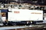 RhB - Lb-v 7859 am 10.03.1998 in Samedan - Container-Tragwagen mit RhB-Container Y11531 2-achsig mit 1 offenen Plattform - Baujahr 1983 bernahme 12.12.1997 - JMR - Gewicht 5,86t - LP 9,14 - Zuladung
