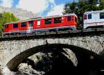 RhB - Regionalzug 1641 von St.Moritz nach Tirano am 01.10.2009 auf Berninabach-Brcke oberhalb Morteratsch mit Triebwagen ABe 4/4 III 53 - ABe 4/4 III 51 - B 2458 - B 2496 - AB 1543 - BD 2574   